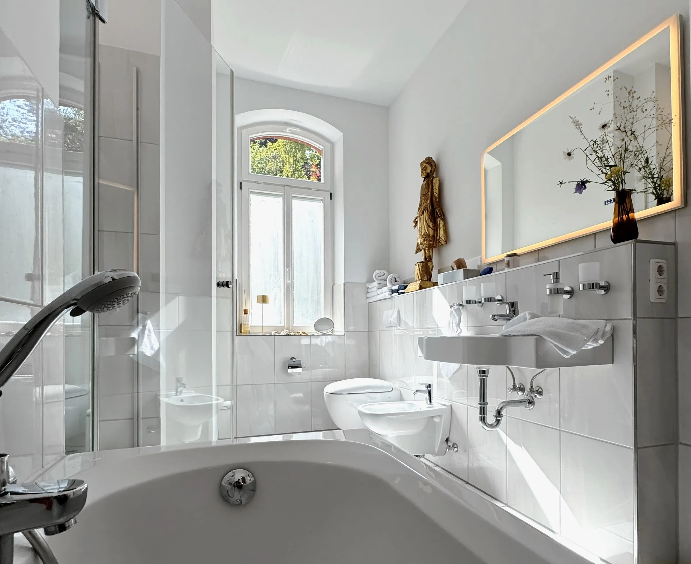 Helles Badezimmer von Apartment 1 mit Wanne und Dusche